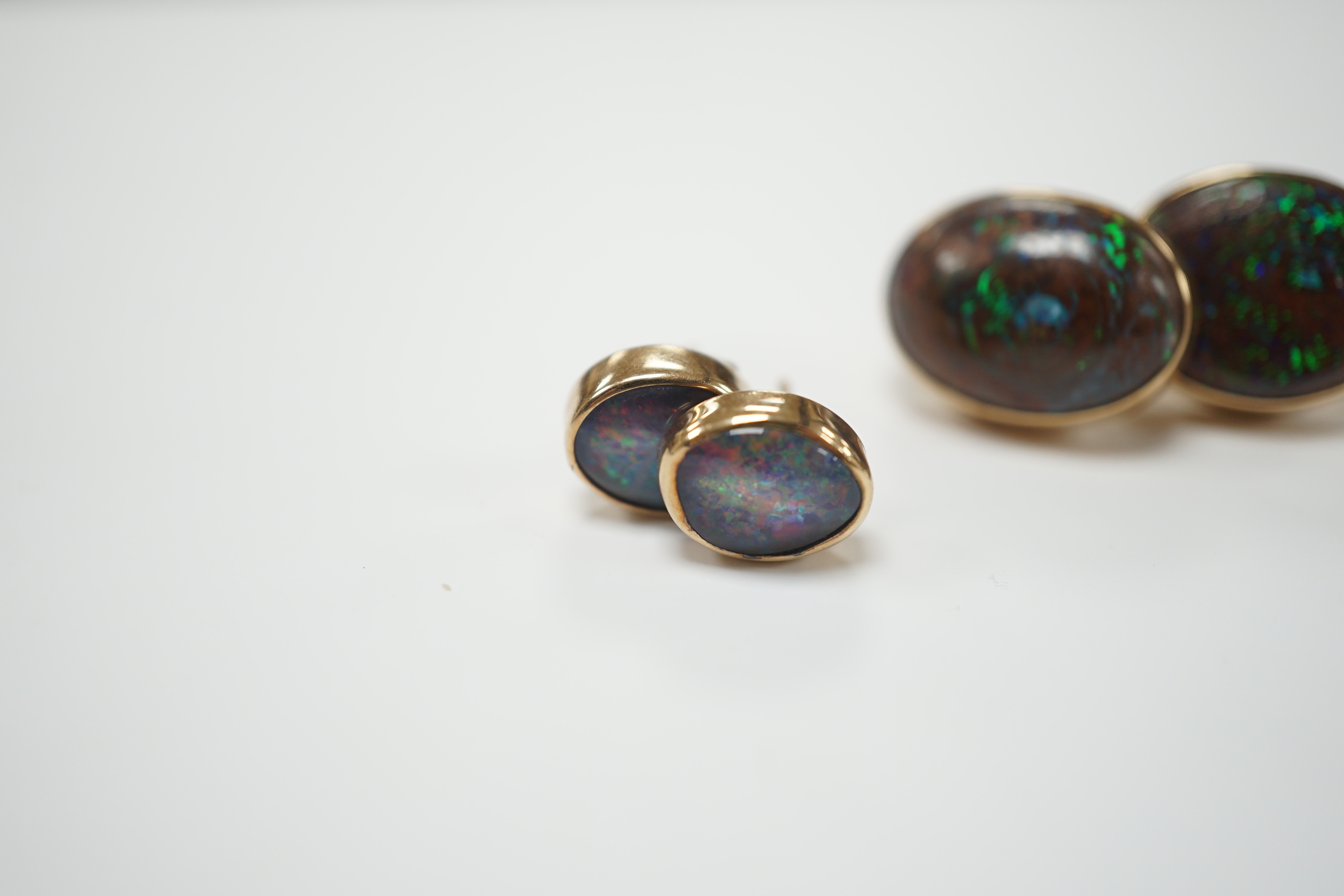 Two pairs of yellow metal and oval opal doublet set earrings, the smaller stamped 9ct, largest 17mm, gross weight 11 grams.